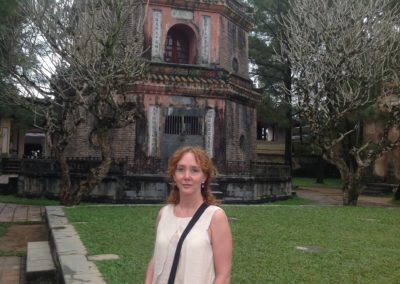 Jennifer Andrews standing by the oldest pagoda in Hue, Vietnam.